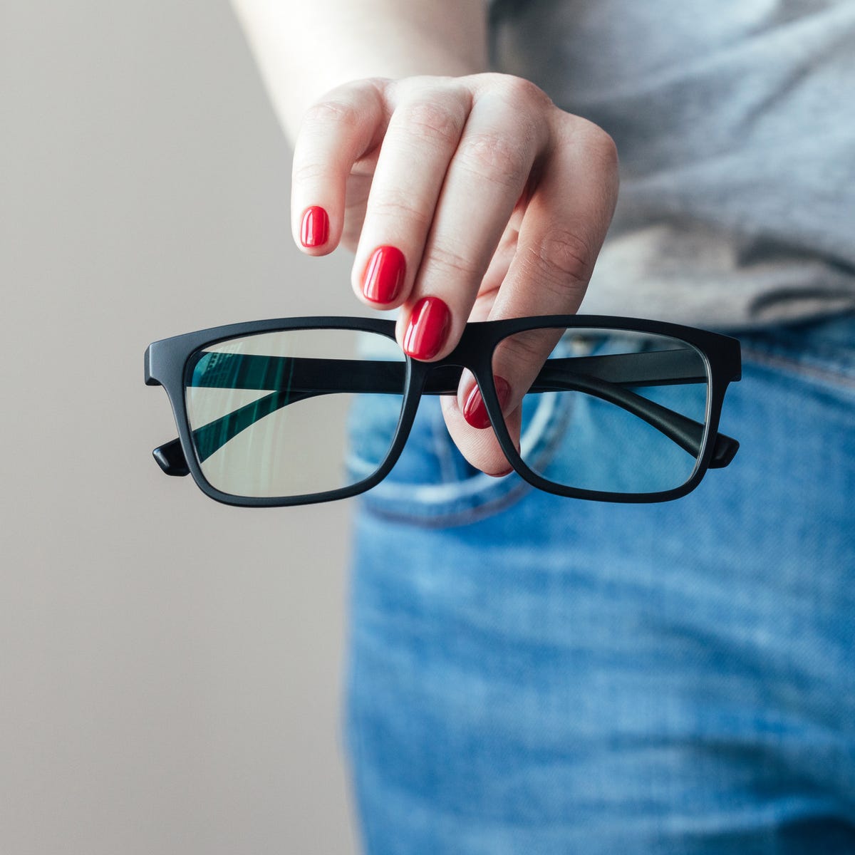 person holding black glasses 1